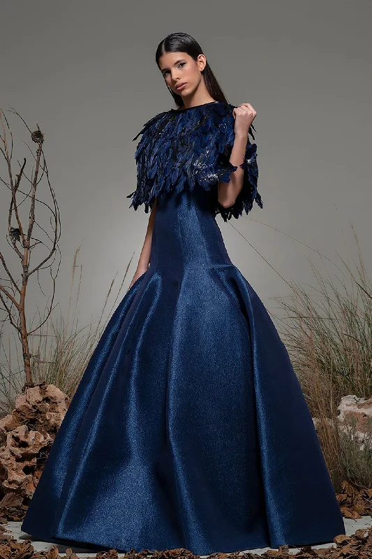 Pleated fit and flare gown featuring feathered cape